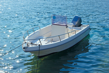 Motor boat in sea. Small white boat in sea water with nobody. - 692521353