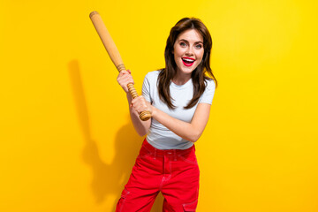 Photo of optimistic dangerous woman with brunette hair dressed white t-shirt swings baseball bat...
