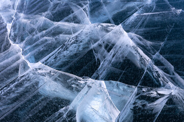 Winter Baikal frozen lake ice texture on frosty January day. Flat lay of beautiful clear ice with a...