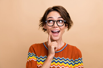 Photo of impressed cheerful clever girl open mouth finger touch chin look empty space isolated on...