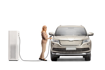 Woman charging an electric SUV at a charging point