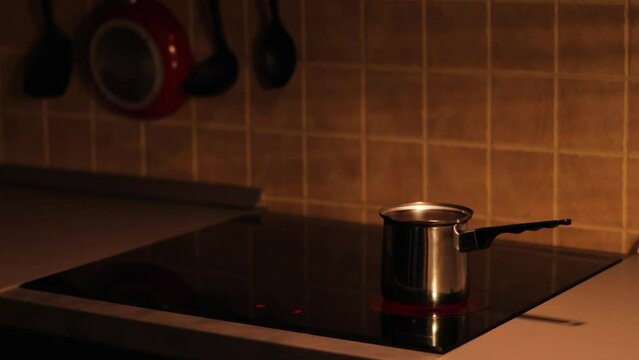 Morning coffee is brewed in a cezve on the stovetop
