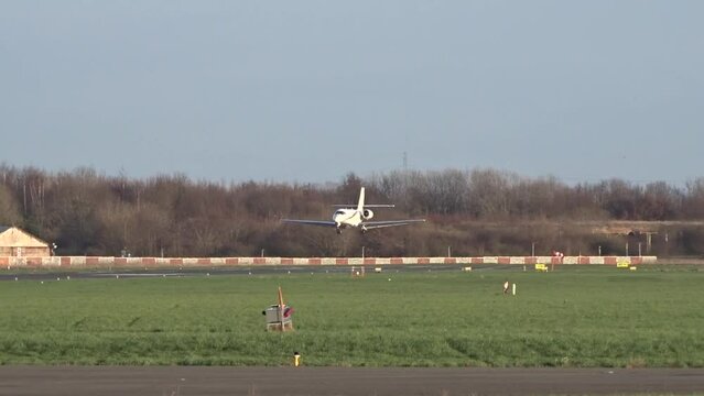 Private Jet Landing at Airport (Private Business Corporate Executive Jet Arriving Arrival Landing Touchdown at Small Regional Airport)