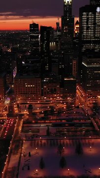 Urban Skyline of Chicago Loop at Night in Winter. Blue Hour. Aerial View. United States of America. Drone Flies Sideways, Tilt Up. Vertical Video