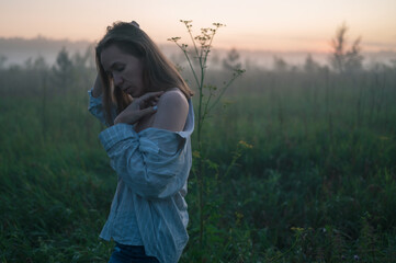 Woman in a field with fog