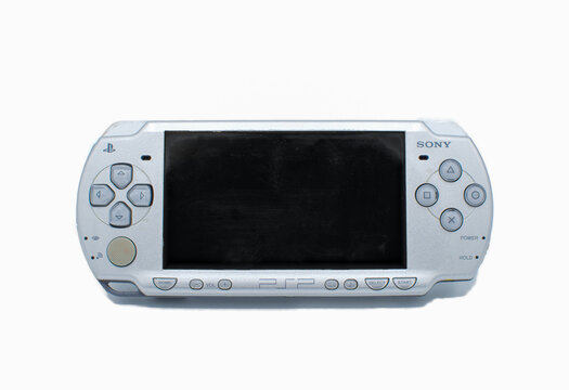 Ocala, Florida USA December 11, 2023 Front view of the famous Sony PSP Playstation Portable UMD universal media disc video game console grey color isolated on white background front view