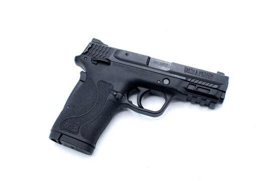 Ocala, FL November 29, 2023. SMITH AND WESSON MP 380 SHIELD EZ Black metal with hard polymer grip 8 round semi automatic clip ammo ammunition. Self defense weapon isolated on white background