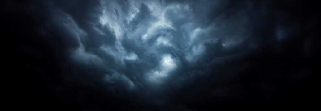 Dramatic sky with storm clouds before rain. Panoramic view of the stormy sky and dark clouds.  Concept on the theme of weather, natural disasters.