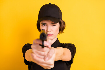 Photo of focused concentrated policewoman aiming pistol at you defense protection isolated on...