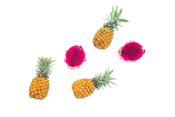 Tropical fruit: pineapple and dragon fruits on white. Flat lay