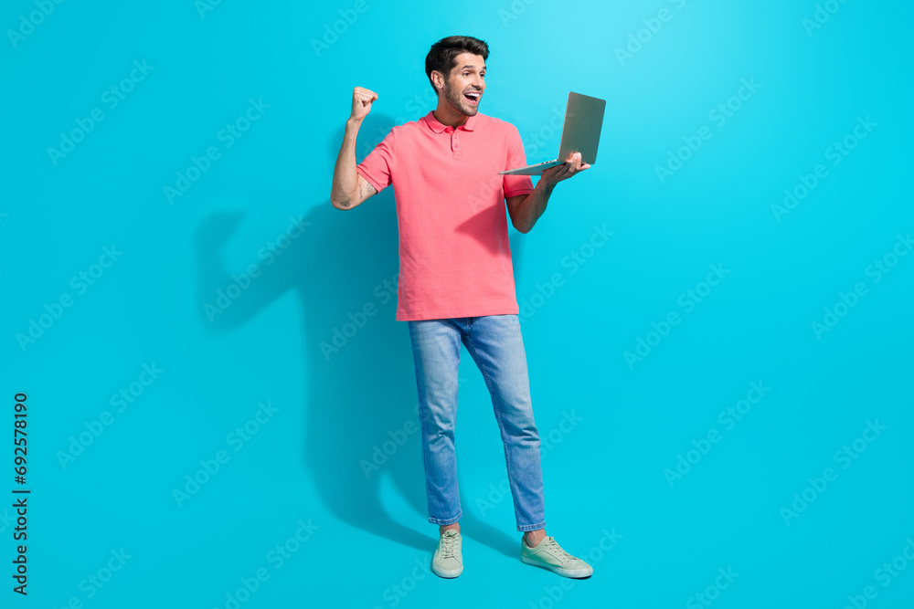 Aufkleber photo of young successful businessman raised fist up using macbook pro and enjoying fast montage iso