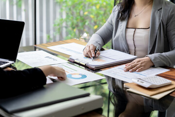 Fototapeta premium Businesswoman Accountant analyzing investment charts Invoice and pressing calculator buttons over documents. Accounting Bookkeeper Clerk&nbsp;Bank Advisor And Auditor