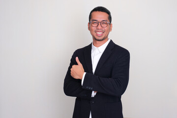 Asian businessman smiling confident and give thumb up with arms crossed