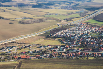 Panorama of a small town and the roads in nature, tilt shift effect