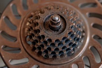 Closeup image of an old bicycle front chain ring sprocket.
