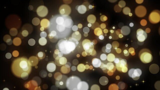 Gold glitter background with defocused bokeh particles lights shiny overlay for luxury christmas or new year holiday greetings.