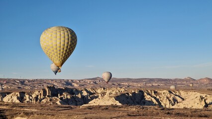 Hot air balloons flying at sunrise in Cappadocia.