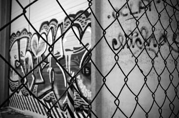 Industrial building on the outskirts, fence and graffiti