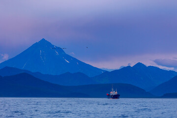 Landscape ship for fishing industry on background Vilyuchinsky Volcano, Kamchatka Peninsula Russia.