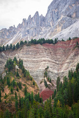 Red colored striated cliff with spruce trees near the foot of the Peitlerkofel (Italian: Sas de Putia) near the Würzjoch Pass in Italy´s Dolomites