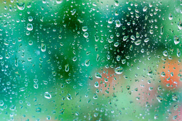 Water drops on glass on green background - 692623713