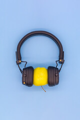 Yellow Apple in headphones listening to music, concept don't be a vegetable, listen to good quality music - 692623728