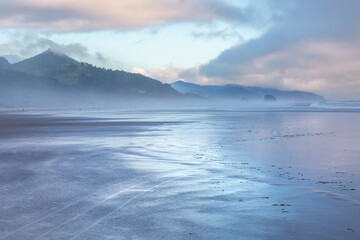 Canon Beach Oregon coast beautiful colorful sunset reflection on the ocean