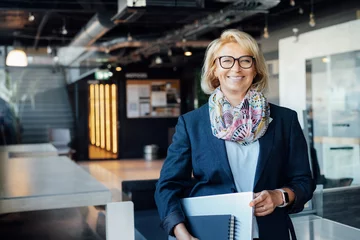 Foto op Plexiglas Portrait of smiling 50's stylish, confident mature businesswoman, middle aged company ceo director, experienced senior female professional, business coach team leader in modern office. Female leader. © okrasiuk