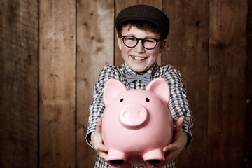 Child, piggy bank or excited in portrait by studio background, savings or finance lesson in youth....
