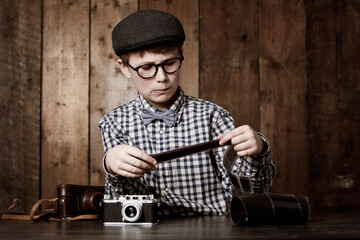 Photography, child and vintage with camera film, thinking and mockup in glasses by backdrop. Boy,...