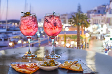pink colorful aperitif with appetizers in a Mediterranean setting - obrazy, fototapety, plakaty