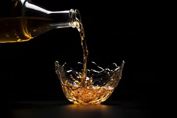 Foto op Plexiglas Olive oil pours out of a bottle on a black background © DK_2020
