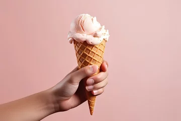Foto auf Alu-Dibond Female hand holding an ice cream cone on peach background © DK_2020