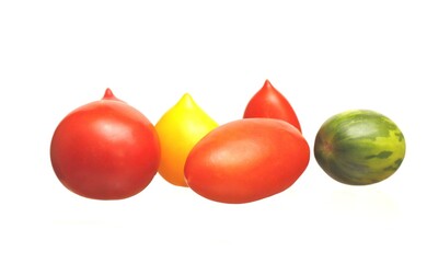 Multi-colored tomatoes on a white background.