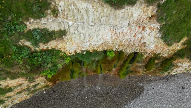 Waterfall on Atlantic ocean sea coast, beach. Beautiful epic nature landscape,  La Roche qui Pleure, Normandy, France, Drone Aerial view Travel destination, cascade