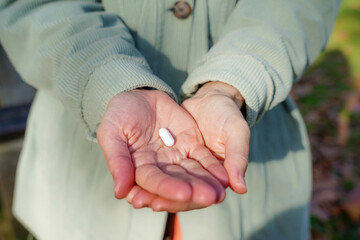 close-up of hands with a pill to say no to drugs