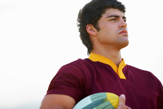 Face, thinking and male rugby player with a ball for competitive game strategy on a white background. Vision, idea and athlete with an object for fitness plan and sports exercise uniform