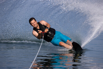 person carving a turn on a slalom waterski