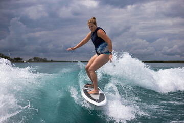 woman surfing on a boat wake