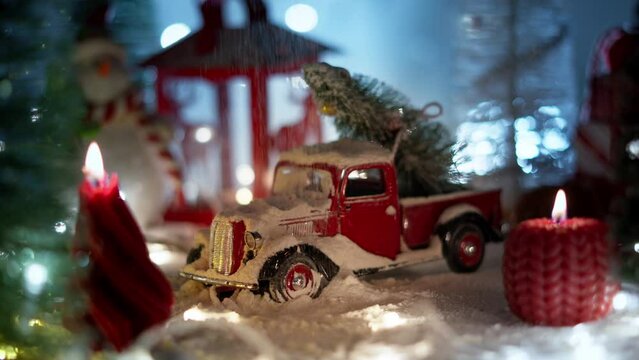 A Christmas display with a miniature car and a Christmas tree on the roof. A warm cinematic shoot in retro style with a large film grain.