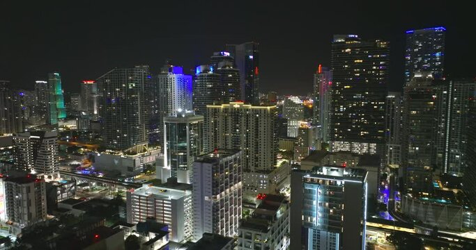 Miami Brickell in Florida, USA at night. Aerial view of brightly illuminated American downtown office district. High commercial and residential skyscraper buildings in modern US megapolis