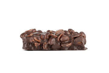 A bar of cake covered with nuts and filled with chocolate on a white background.