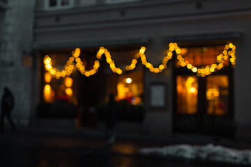Blur restaurant, store or xmas cafe on night time during Christmas celebrations at old city town of...