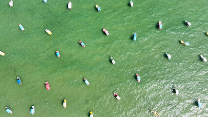 Naklejka premium Colorful boats floating on the water in San Miguel de Milagres in Brazil.