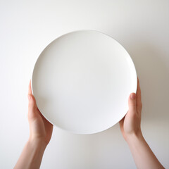 a person holding a white plate