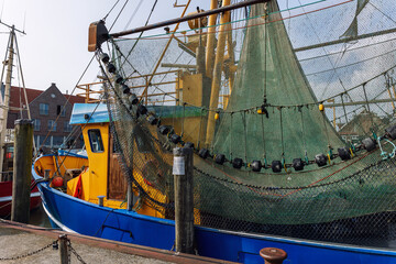 Traditional old german fishing cutter boats moored Neuharlingersiel harbor Wadden sea East Frisia...