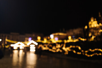 Blurred stylish christmas golden illumination and Christmas tree. Krakow, Poland, Main Square and...