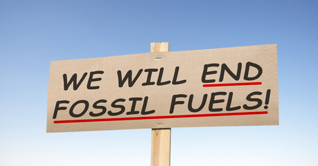 Cardboard sign with the motto; WE WILL END FOSSIL FUELS!