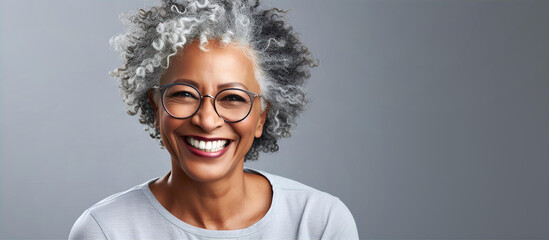 Portrait of very beautiful aged black woman with grey hair sliming to camera.