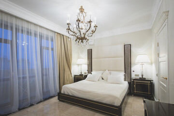 Classic interior with table, marble, chandeliers, wood